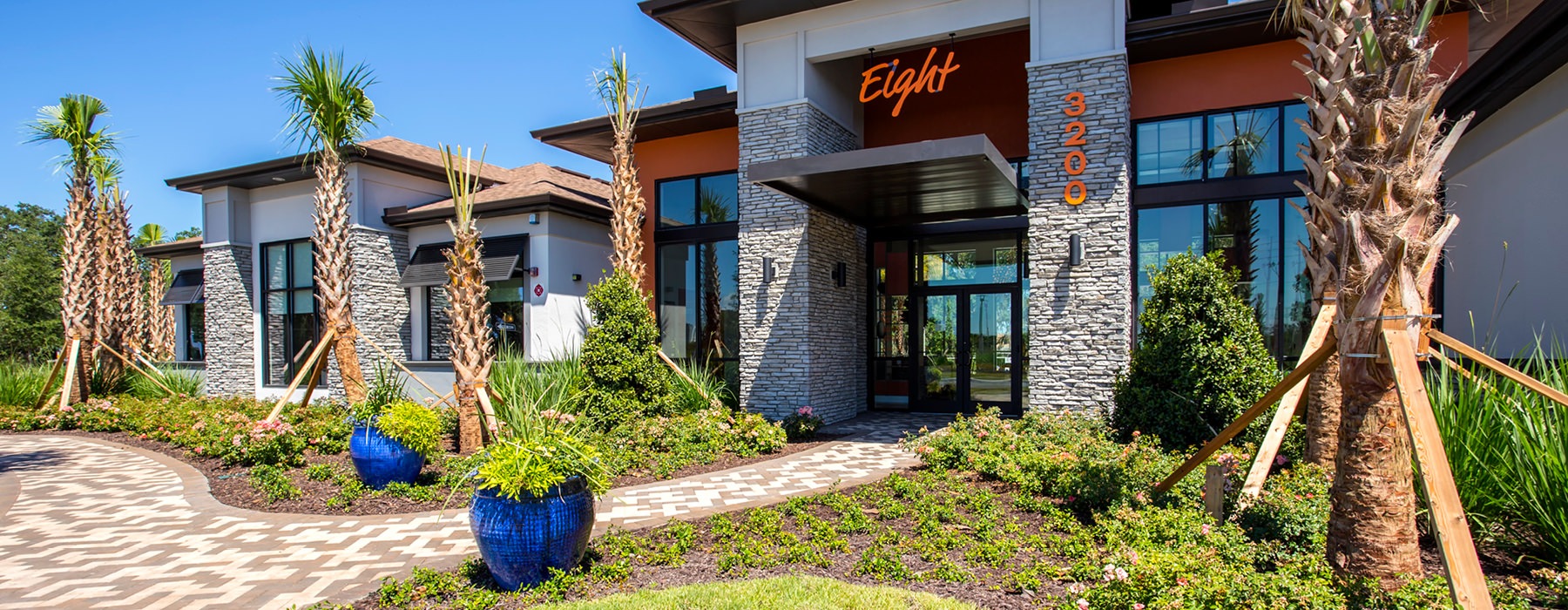 Eight entrance with lush landscaping
